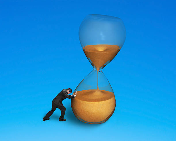 istock male pushing tilt hourglass 512522889