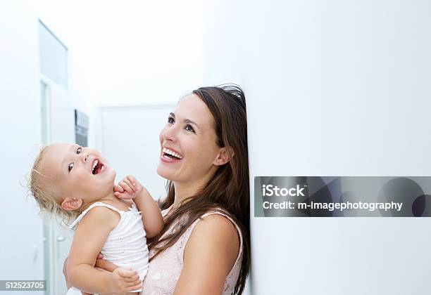 Mother And Baby Girl Laughing Together Stock Photo - Download Image Now - 12-17 Months, Activity, Adult