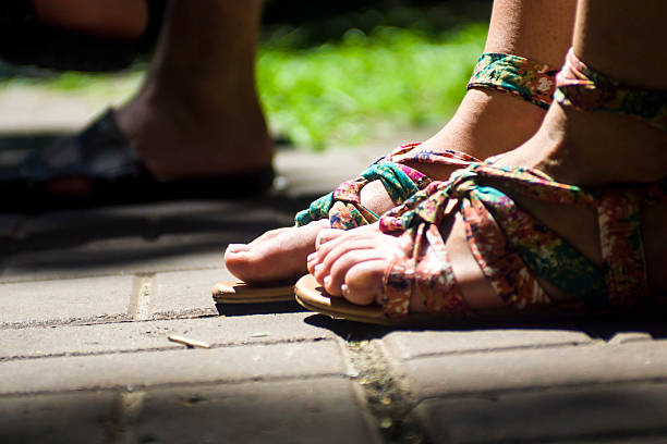 istock Feet in sandals on fone tiles 512523907