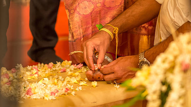 istock Bridegroom places ring on the brides toe 512523915