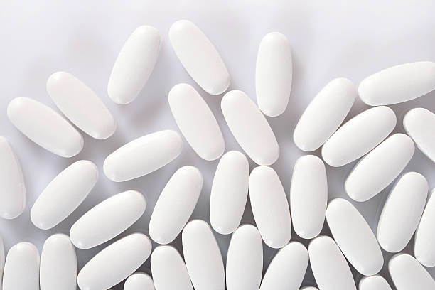 istock Top view of white pills on a white 512524006