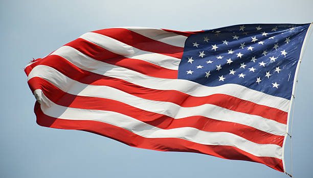istock American flag waving in a sky 512524103