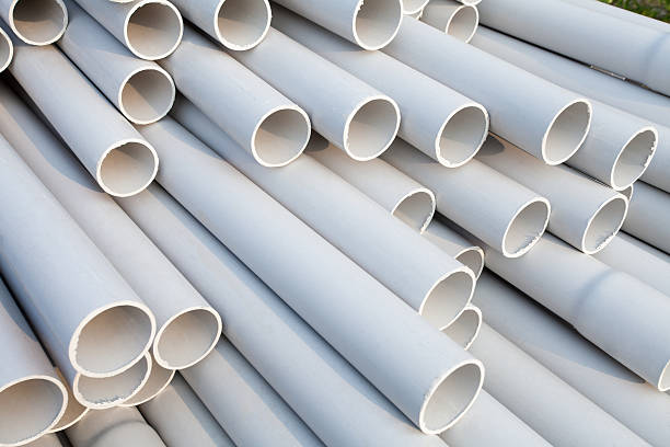 PVC pipes Heap of PVC pipes stacked at construction site, Close-up. pvc stock pictures, royalty-free photos & images