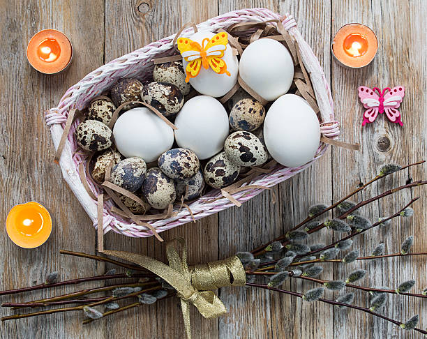 istock Easter decorations - eggs, candles, pussy-willow branches on a w 512524524
