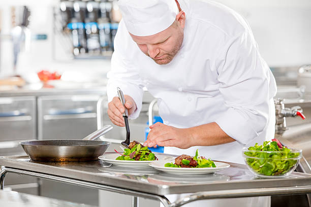 istock Professional chef prepare steak dish at restaurant 512525740