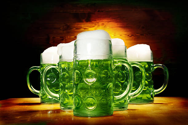 Five Green Beer Glasses on the Wooden Table Five Big Green Glasses of Beer Standing on the wooden Table on the Wooden Background large german beer steins stock pictures, royalty-free photos & images
