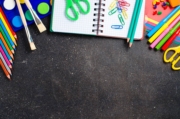 istock School supplies on dark table 512527506