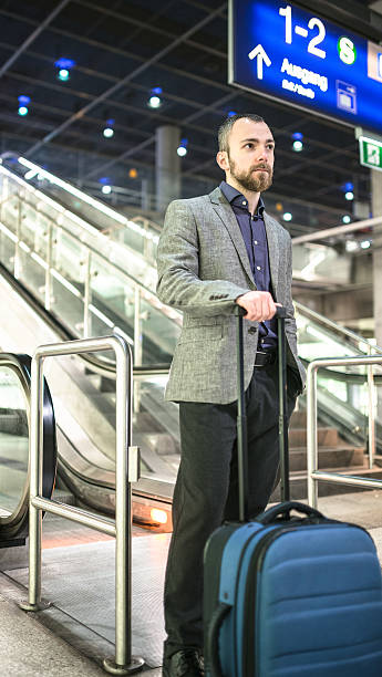 istock businessman waiting the train platform at the station 512535806