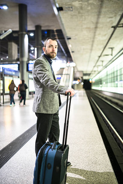 istock businessman waiting the train platform at the station 512536178