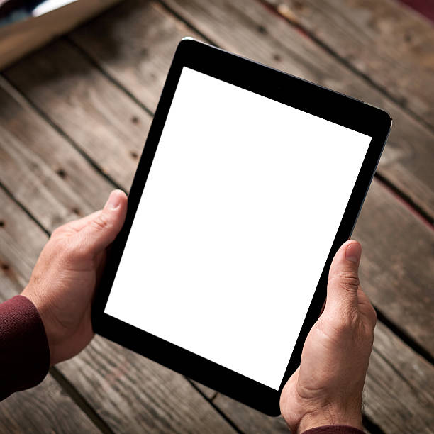 istock Man shows screen of tablet in his hands 512536858