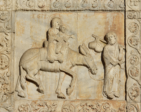 Medieval relief of Jesus flight ot Egypt with Virgin Mary and Saint Joseph, from Basilica of San Zeno facade, in Verona (12th century)