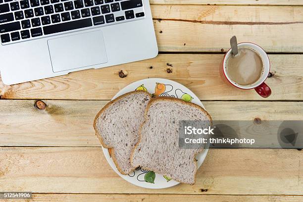 Laptop Bread And A Red Cup Of Coffee On Wooden Stock Photo - Download Image Now - Baked Pastry Item, Bakery, Bread