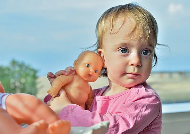 istock Little girl and doll. 512542420