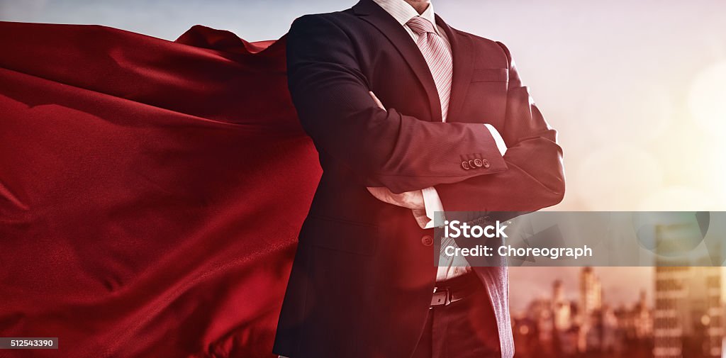 superhero businessman looking at city superhero businessman looking at city skyline at sunset. the concept of success, leadership and victory in business. Superhero Stock Photo