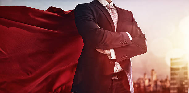 superhero businessman looking at city superhero businessman looking at city skyline at sunset. the concept of success, leadership and victory in business. superhero photos stock pictures, royalty-free photos & images