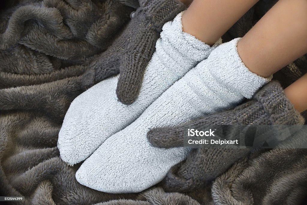 Feet in comfortable and warm woolen stocks on a blanket Sock Stock Photo