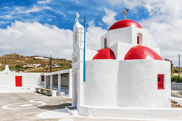 White chapel with red dome in Tourlos, Mykonos stock photo