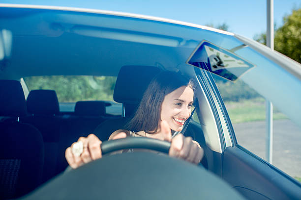 istock Young woman driving car. Windshield view 512547113