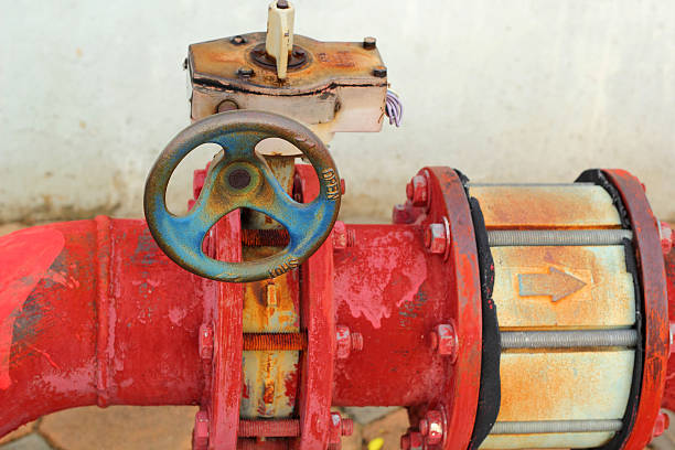 istock red rusty metal industrial water pipes with a valve. 512547757