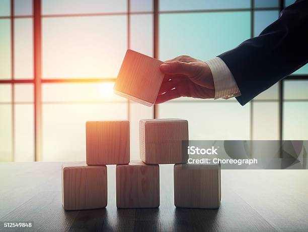 Men Holding The Cubes Stock Photo - Download Image Now - Wealth, Building - Activity, Construction Industry