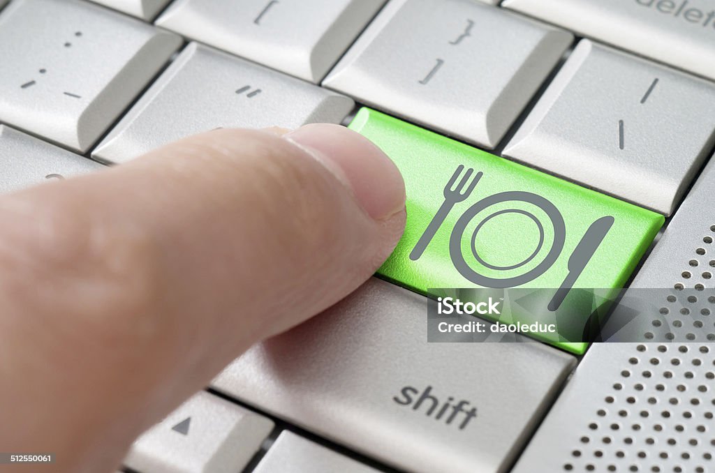 Online food ordering concept Online food ordering concept with human finger pointing a keyboard Business Stock Photo