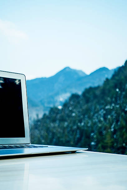 istock Laptop on desk with mountain 512550378