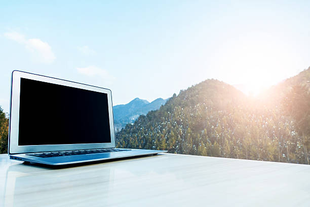 istock Laptop on desk with mountain 512550700