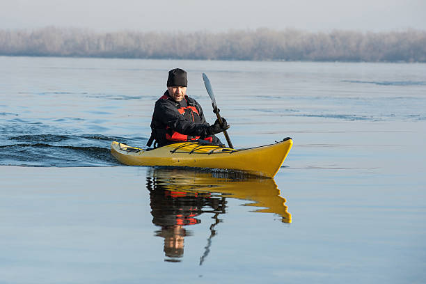 человек с каяке - winter river стоковые фото и изображения