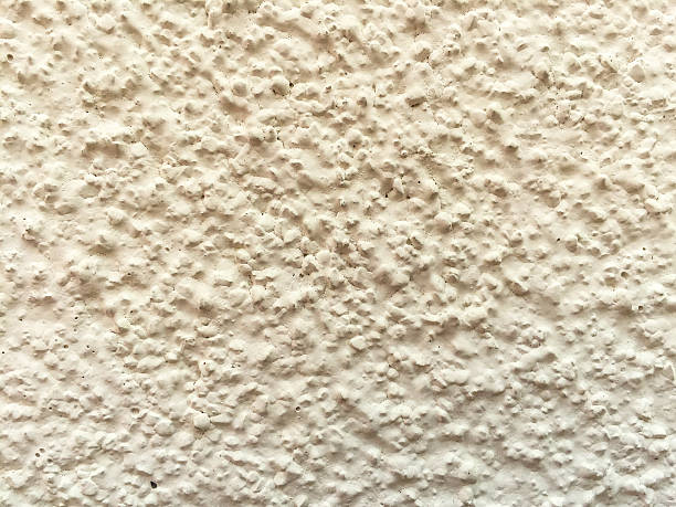 istock White textured background on the side of a building. 512551400