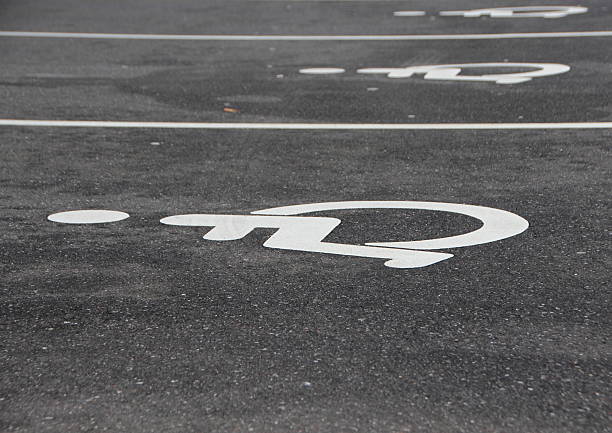 istock White Handicap Disabled Sign on Black Asphalt 512551776