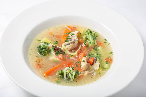 istock Light fish soup with vegetables and broccoli in white plate. 512551860