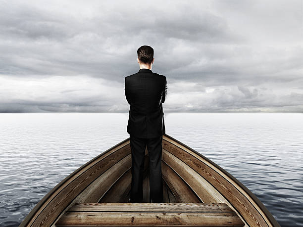 istock businessman standing on a boat 512552524