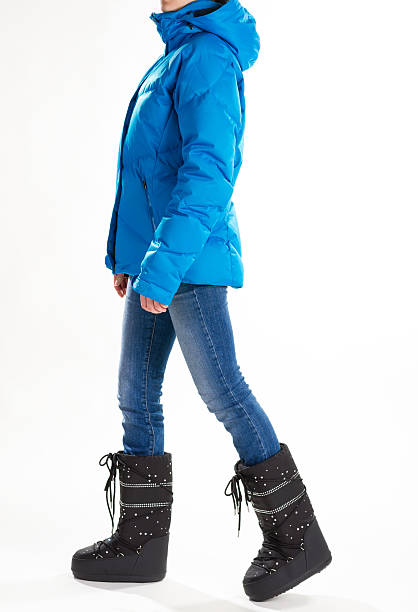 istock Girl in warm down jacket and moon boots. 512553054