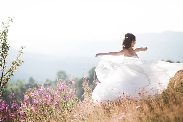 istock Gorgeous bride in elegant dress posing at sunny summer day 512554294