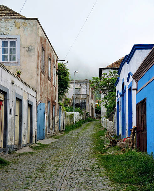 istock Narrow cobblestone street between houses 512567626