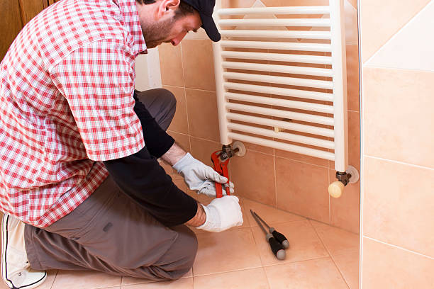 istock Plumber performs a repair of a radiator 512568948