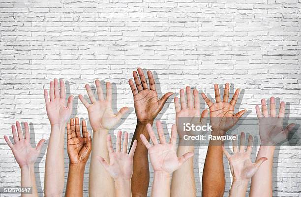 Hand Raised On Brick Wall Stock Photo - Download Image Now - Freedom, Sea Of Hands, Arms Outstretched