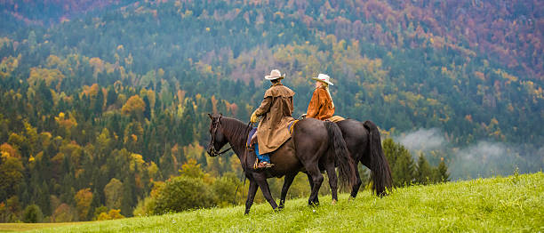 カウボーイとガールの乗馬で、草地 - saddle blanket ストックフォトと画像