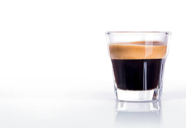 Cup of espresso coffee Close up of a glass of espresso on a black background shot glass stock pictures, royalty-free photos & images