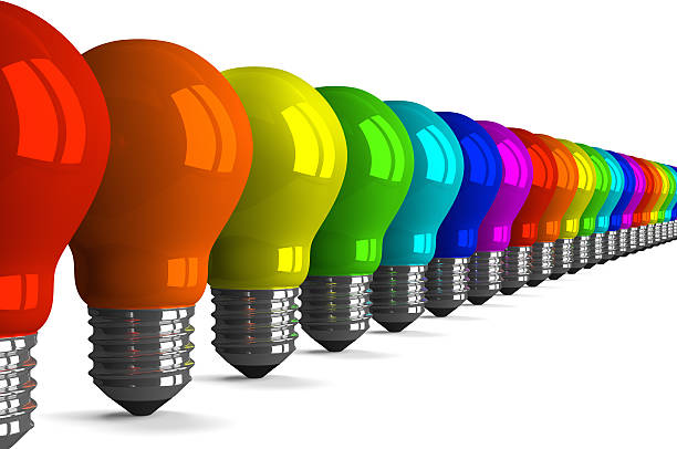 istock Many tungsten light bulbs of rainbow colors, perspective view 512571879