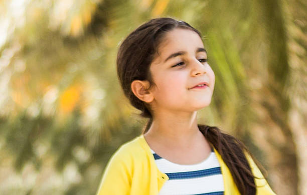 Young girl playing in a park Portrait of a young girl playing in a park. Image from iStockalypse Dubai 2015, United Arab Emirates arabic girl stock pictures, royalty-free photos & images