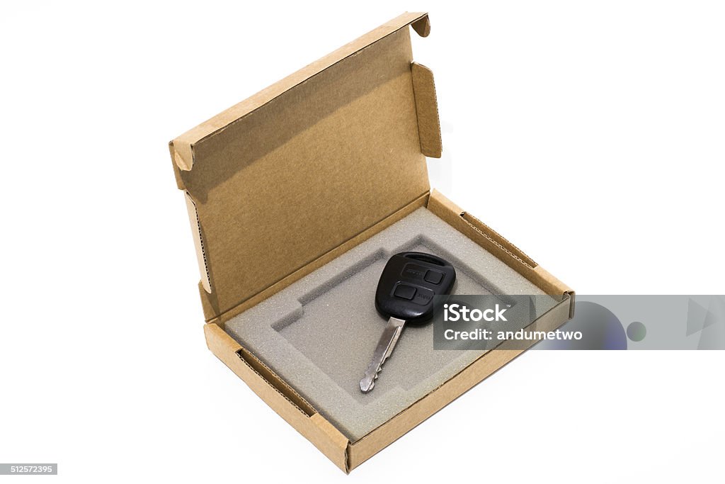 Cardboard box isolated on white with a car key inside Open cardboard box isolated on white with a car key inside Car Key Stock Photo