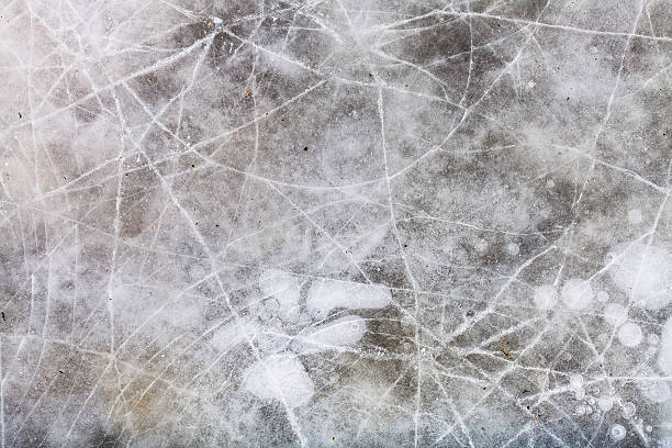 istock cracked ice on frozen puddle in winter 512572686