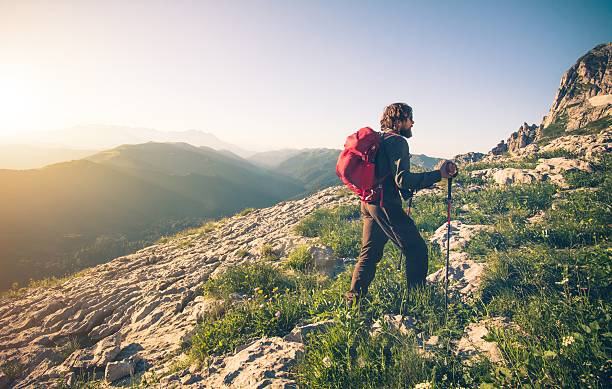 istock Young Man with backpack mountaineering outdoor 512572778