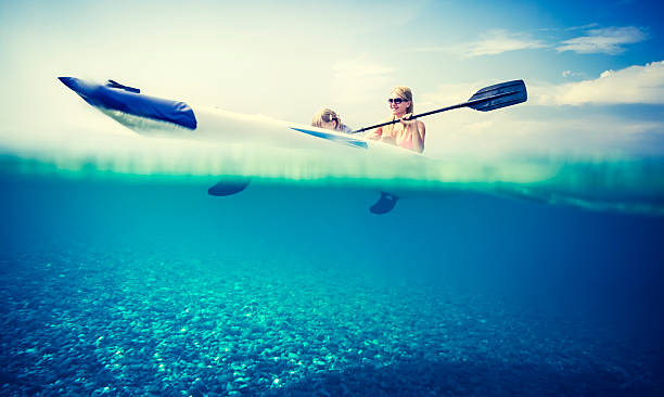 istock Family kayaking on sea with underwater view 512572931