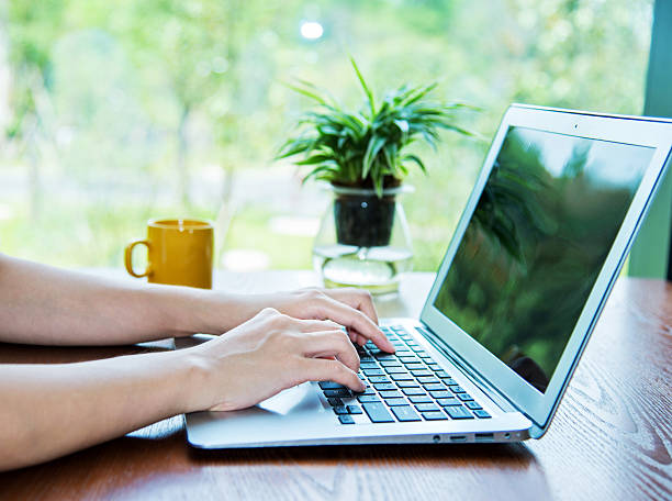 istock Woman hand typing on laptop 512573898