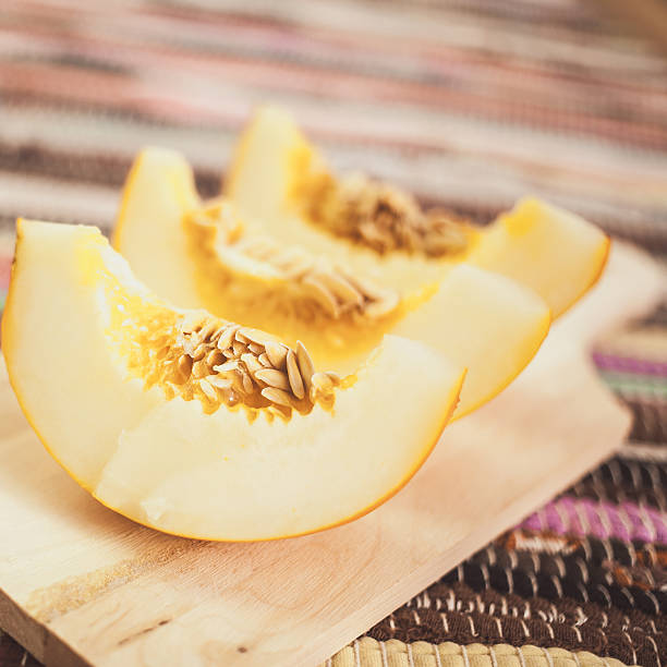 istock fresh melon on a wooden cutting board. selective focus 512574973