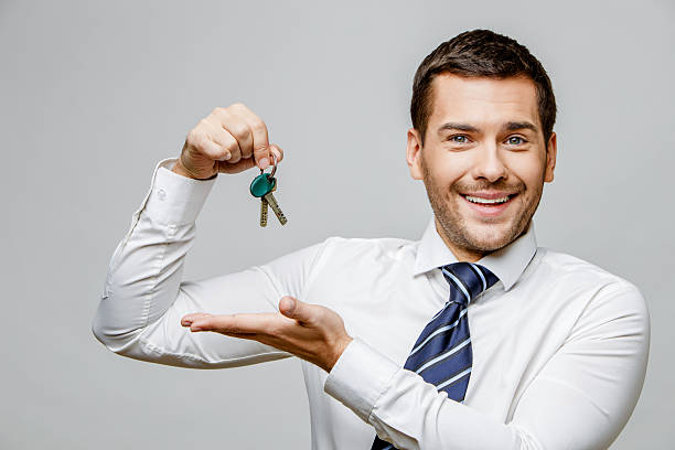 istock Handsome stylish businessman on grey background 512575098