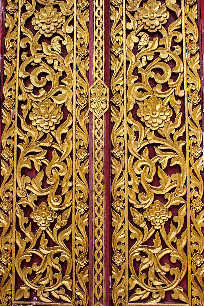 istock Ancient art pattern on the wooden door in Thai temple 512576925