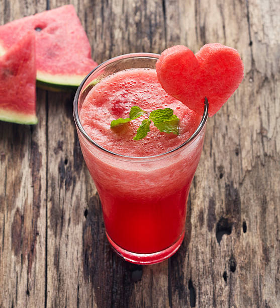istock Water melon smoothie and fresh melon on wood background 512578071